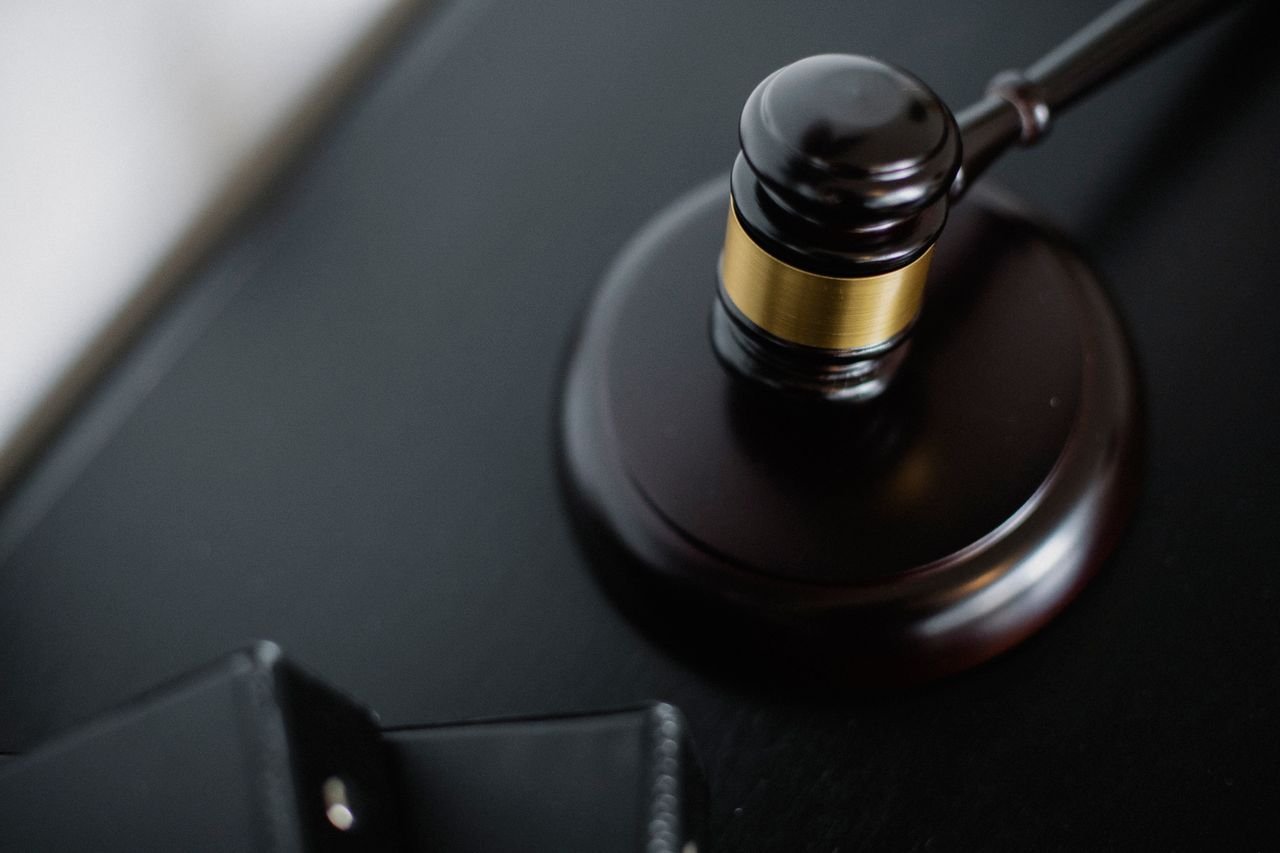 Crafting Captivating Headlines: Your awesome post title goes here From above of wooden gavel on round surface near folders on table in courtroom