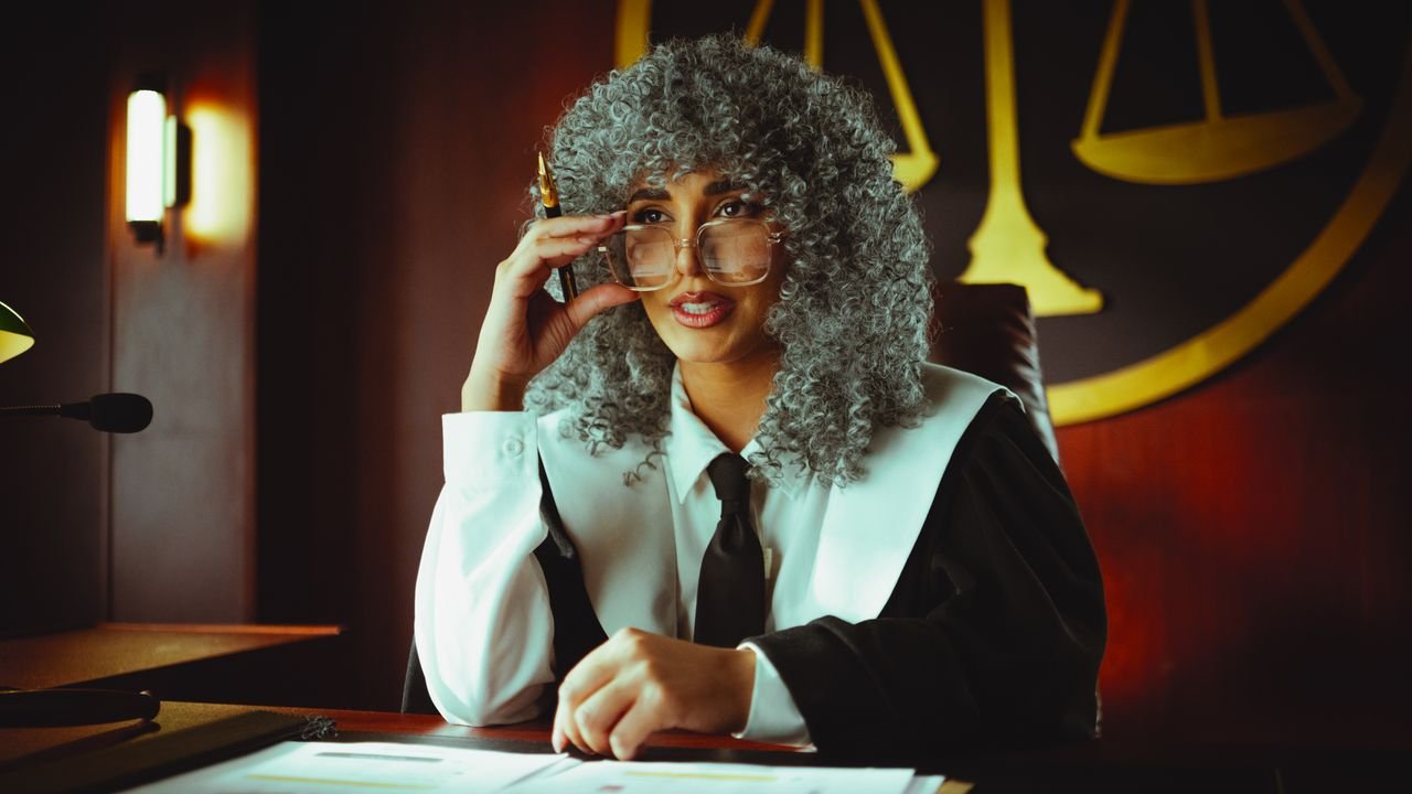 Mastering the First Impression: Your intriguing post title goes here An elegant judge in robes sits at a desk in a courtroom, poised and authoritative.